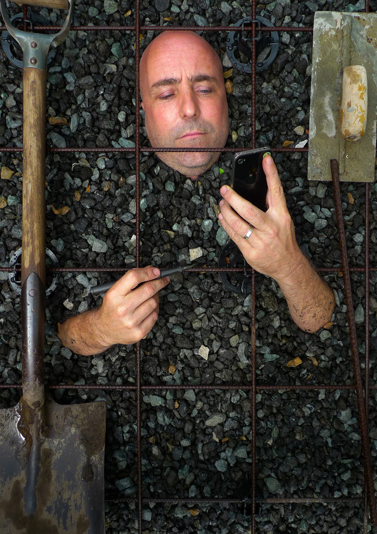 The winning photo of the 2012 Shoot the Architect Competition shows architect Angus Munro still looking a his phone and with pen in hand as a concrete pour in imminent